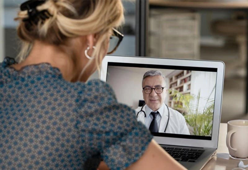 Patient meeting with a physician over telemedicine video call